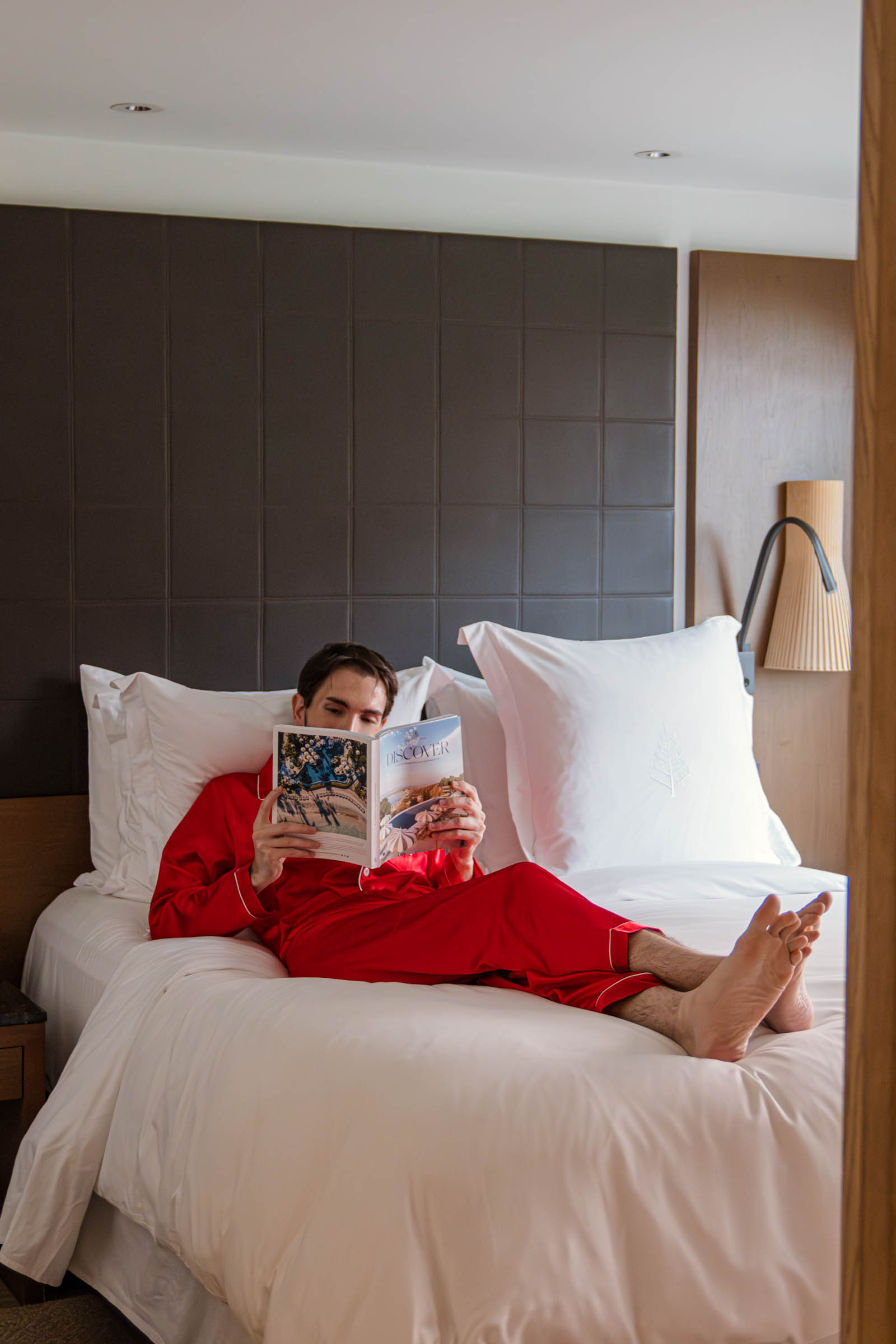 Marko Tadić (Mr.M) is reading a Four Seasons magazine on the king size bed in the One Bedroom Premier Suite apartment.
