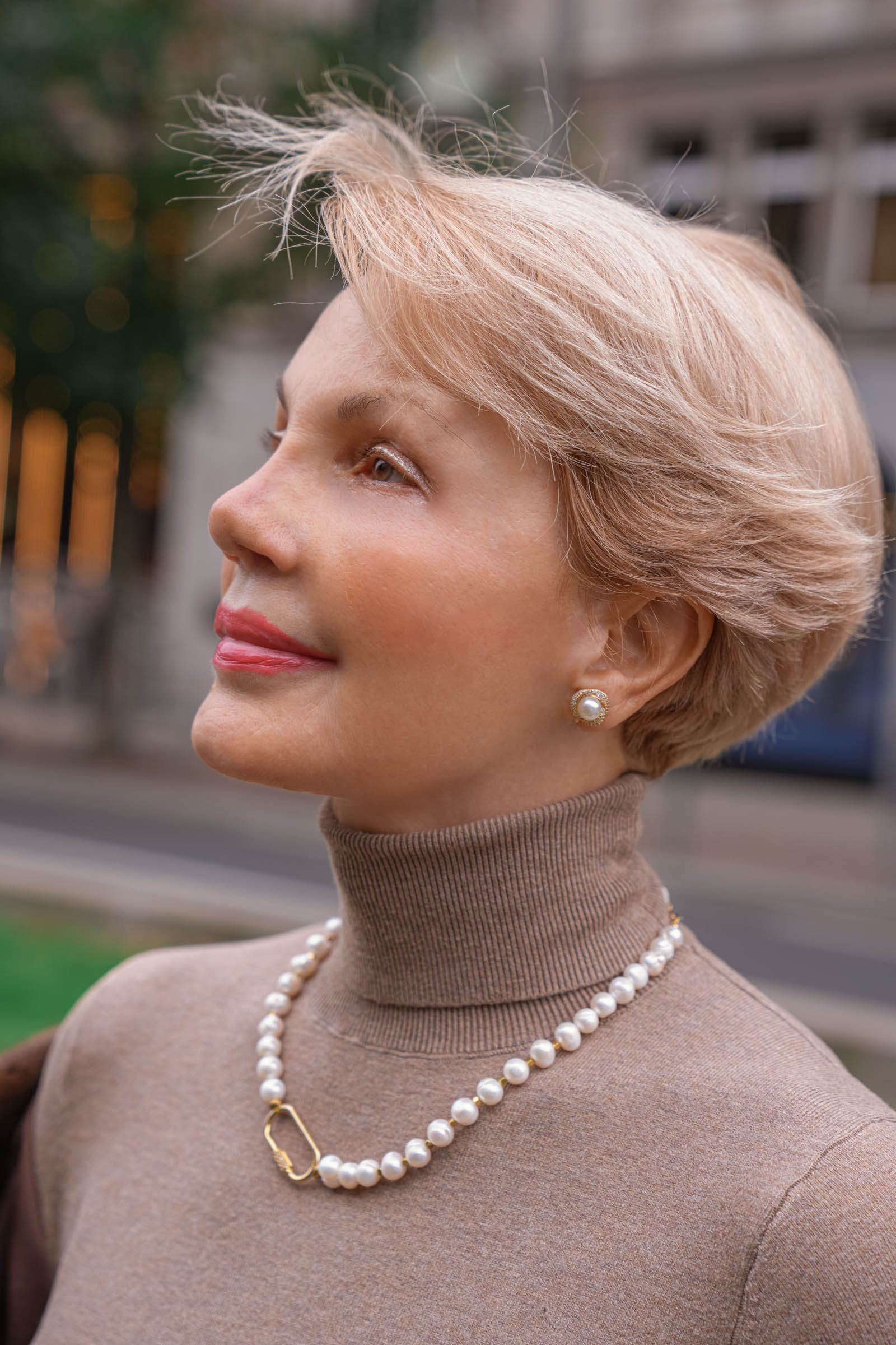 Elegant portrait of Ružica Rose Tadić known as Mrs. Mom on the Mr.M fashion blog, showcasing a Fendi mink jacket in warm brown tones and a Max Mara pure cashmere turtleneck in beige, paired with a Tasaki pearl necklace featuring a gold oval clasp set with diamonds.