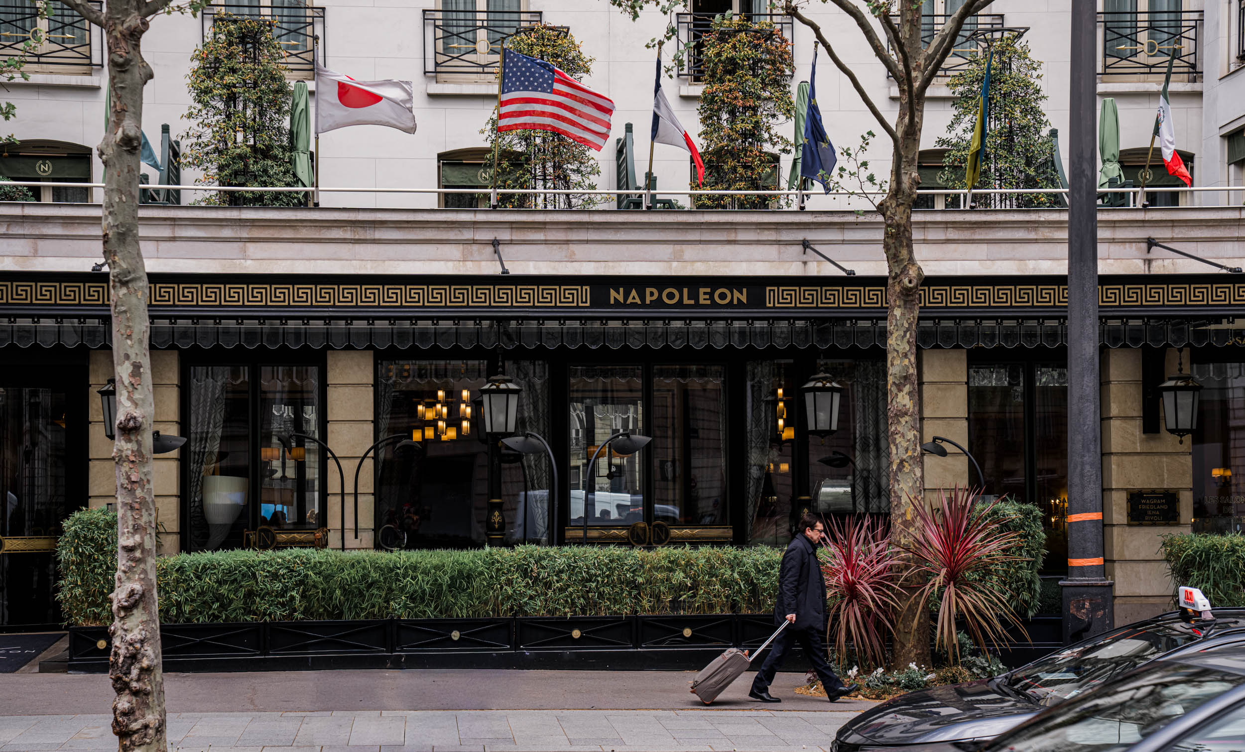 Facade of Hôtel Napoléon on Avenue de Friedland in Paris flying international guest flags