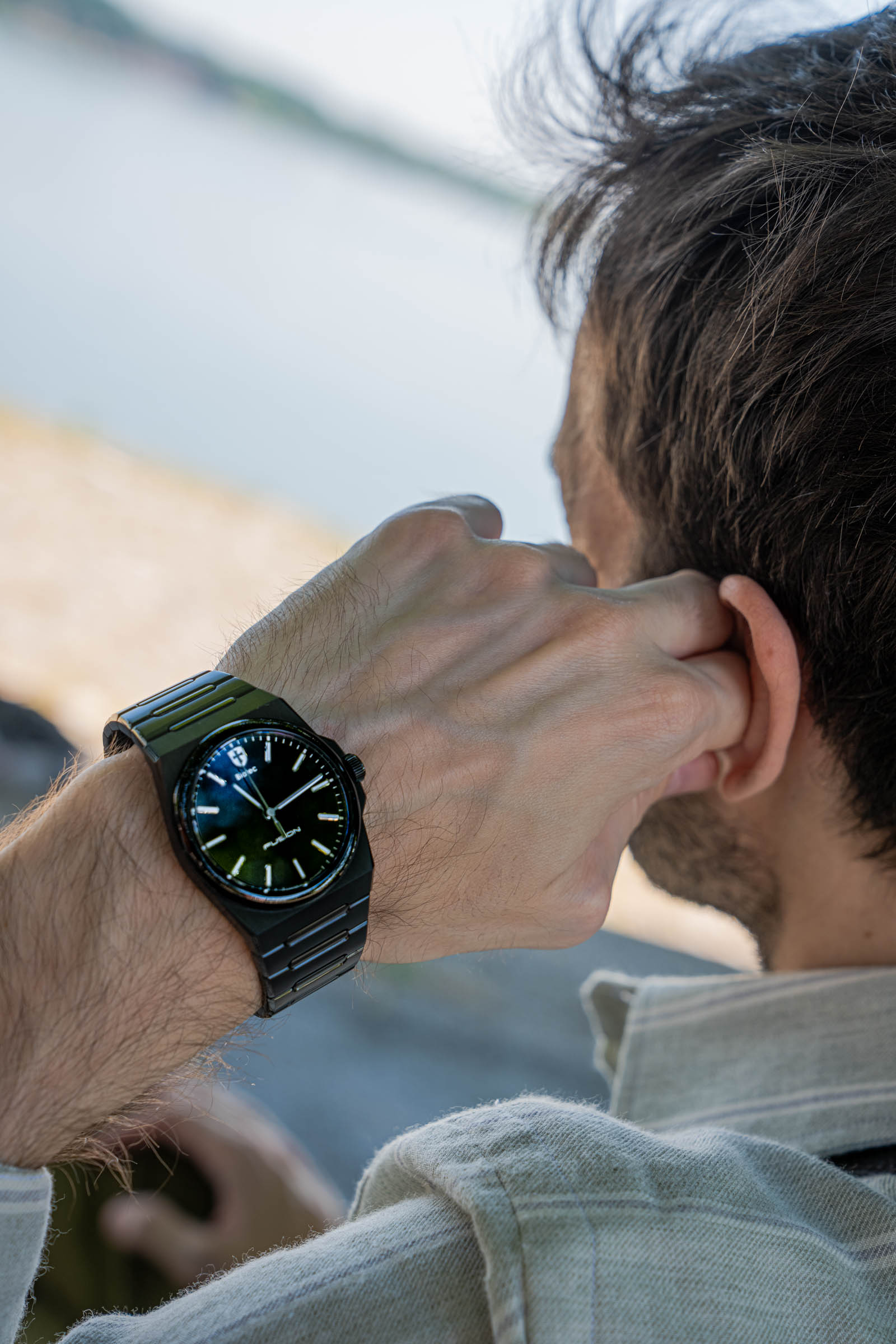 Close-up of the black Biatec Fusion 03 on Marko Tadić's wrist, highlighting the 39 mm brushed and polished DLC case that fuses seamlessly into its integrated bracelet, a homage to iconic 1970s watch design.