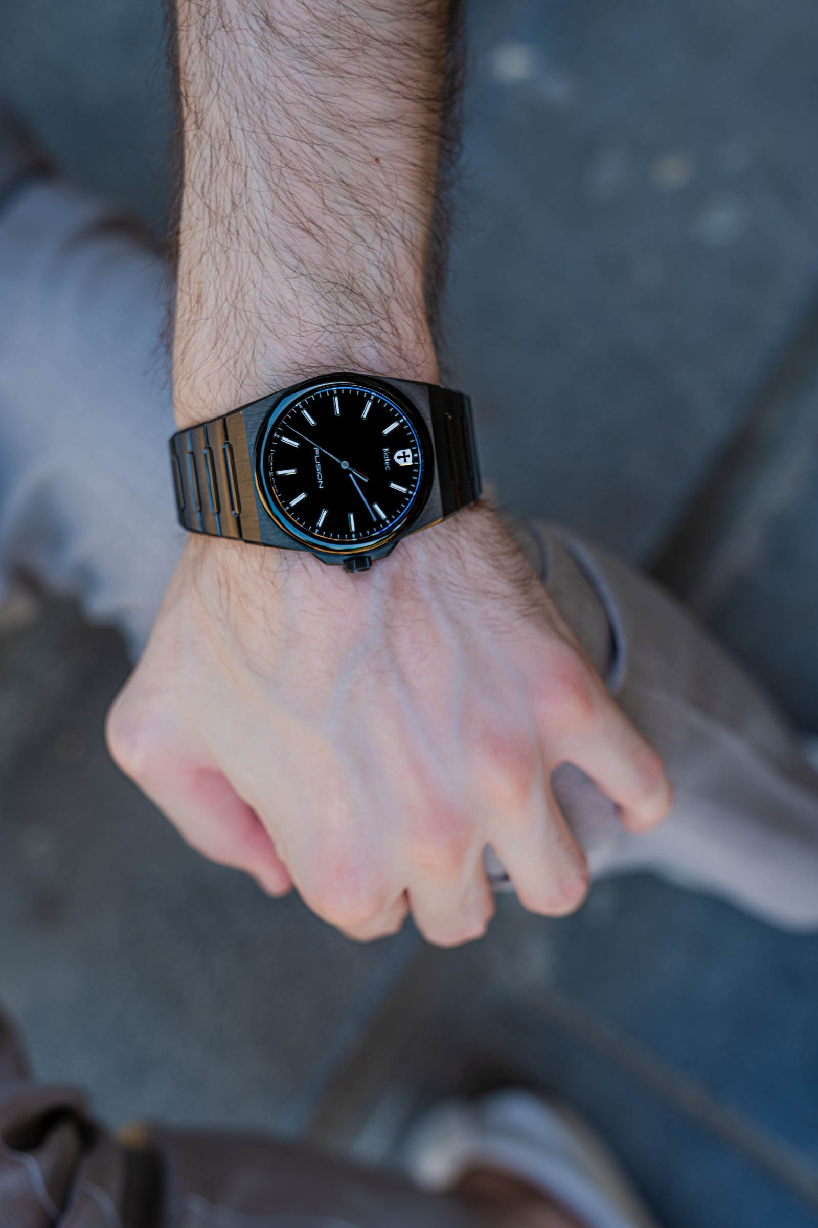 Close-up of the Biatec Fusion 03 black automatic watch with luminous indexes on the raised wrist of Marko Tadić, founder of the Mr.M blog
