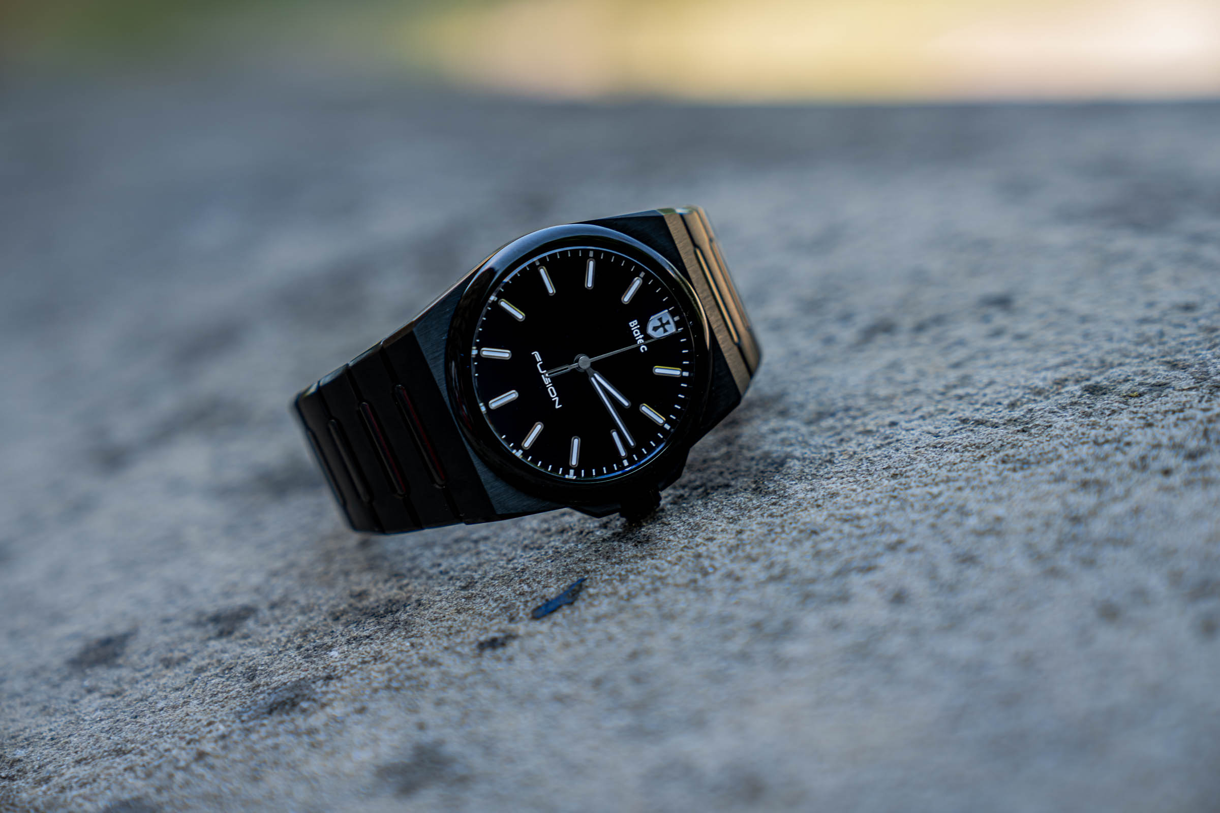 The black Biatec Fusion 03 automatic watch with integrated DLC bracelet photographed on a stone surface in Belgrade for the Mr.M blog by Marko Tadić