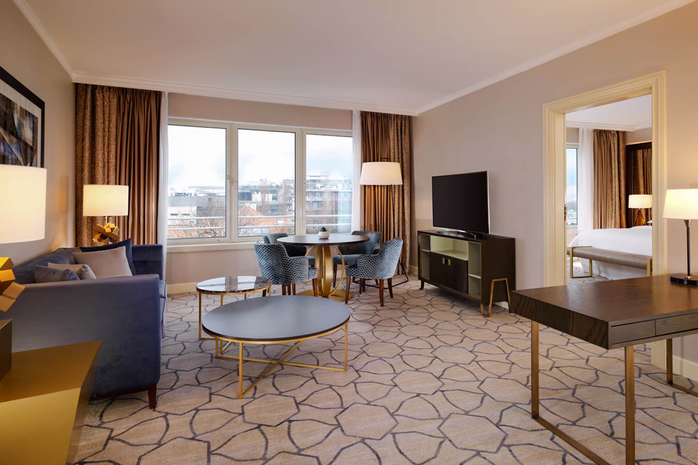 Executive Suite living area at Sheraton Grand Warsaw with sofa, dining table and desk, Mr.M by Marko Tadić