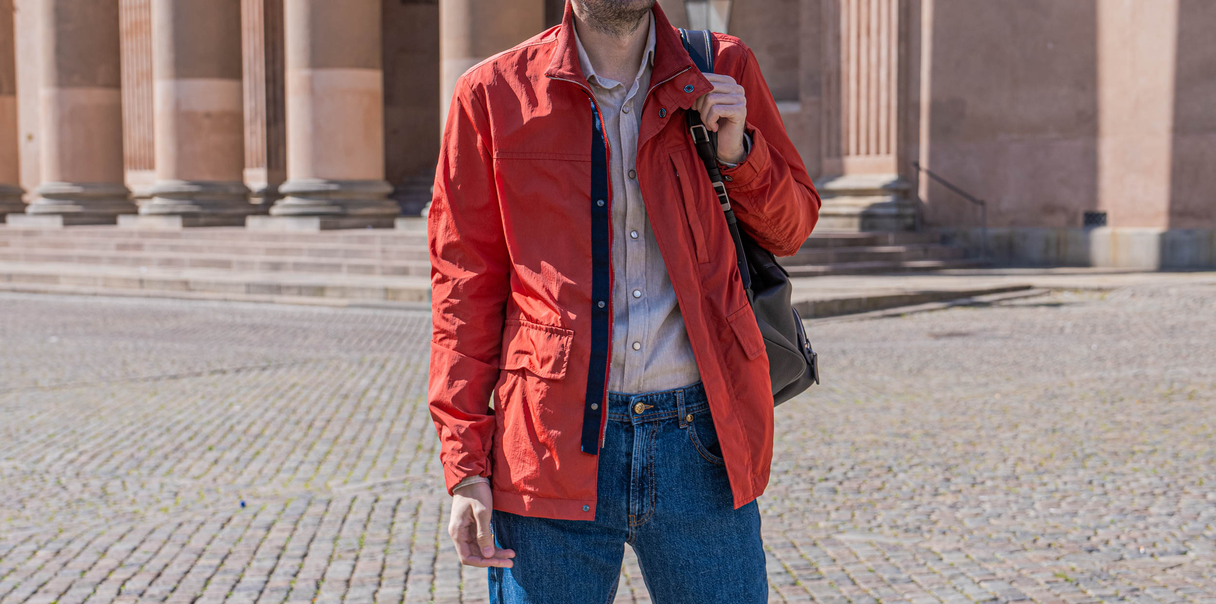 Giannetto Portofino washed cotton flannel shirt in warm sand beige, worn by Marko Tadić with a red Canali field jacket over the shoulder and a 1900 leather backpack on the ledge