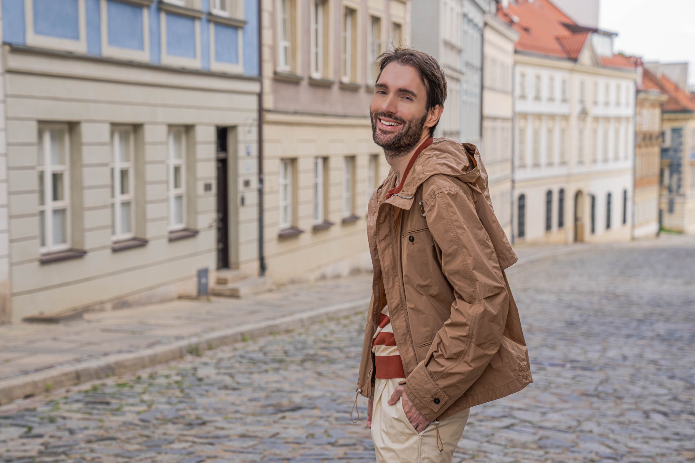 Marko Tadić, founder of Mr.M blog, walking downhill through Warsaw in a striped knit polo