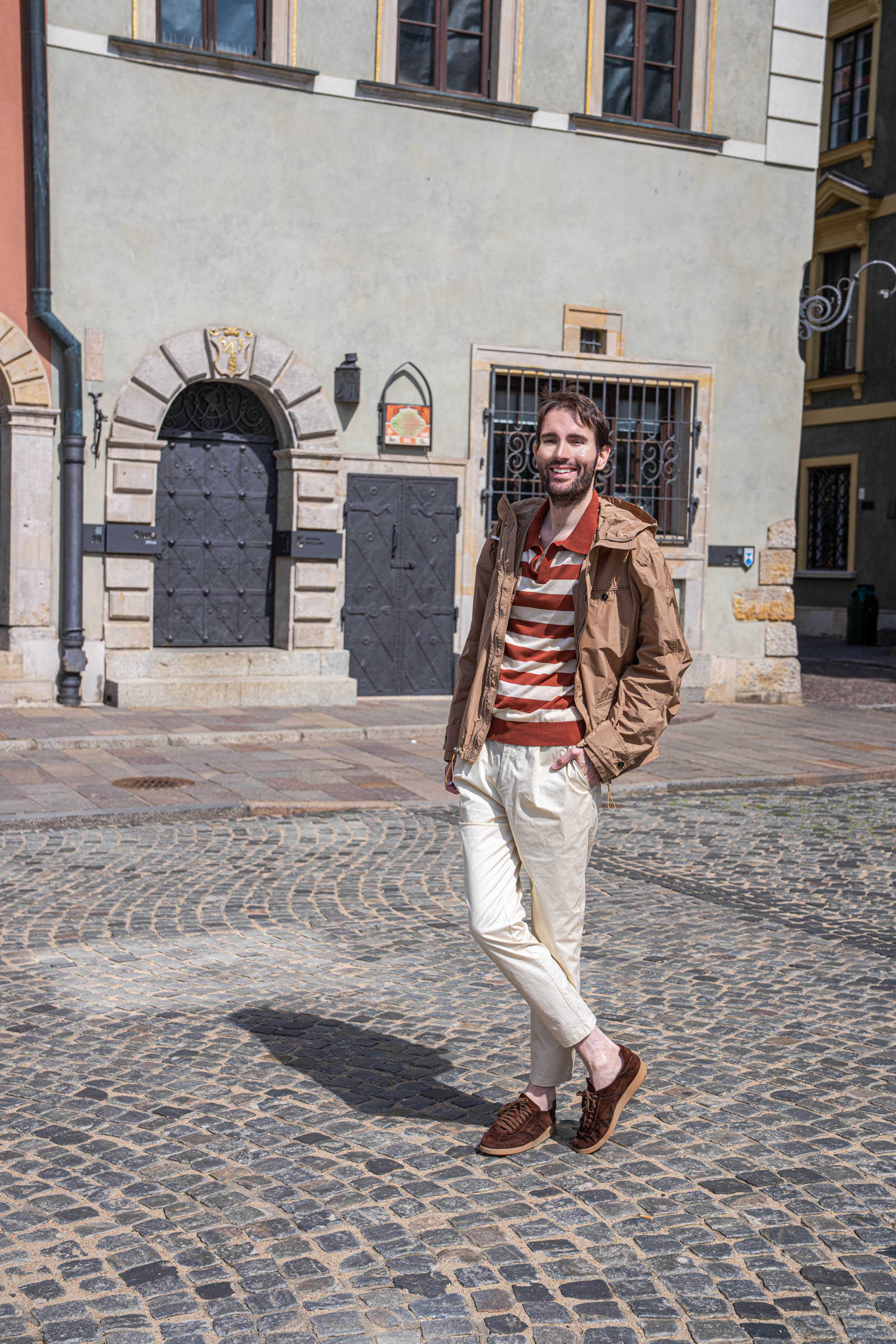 Marko Tadić walking past the Renaissance portal of the townhouse at Rynek Starego Miasta 36 in Warsaw