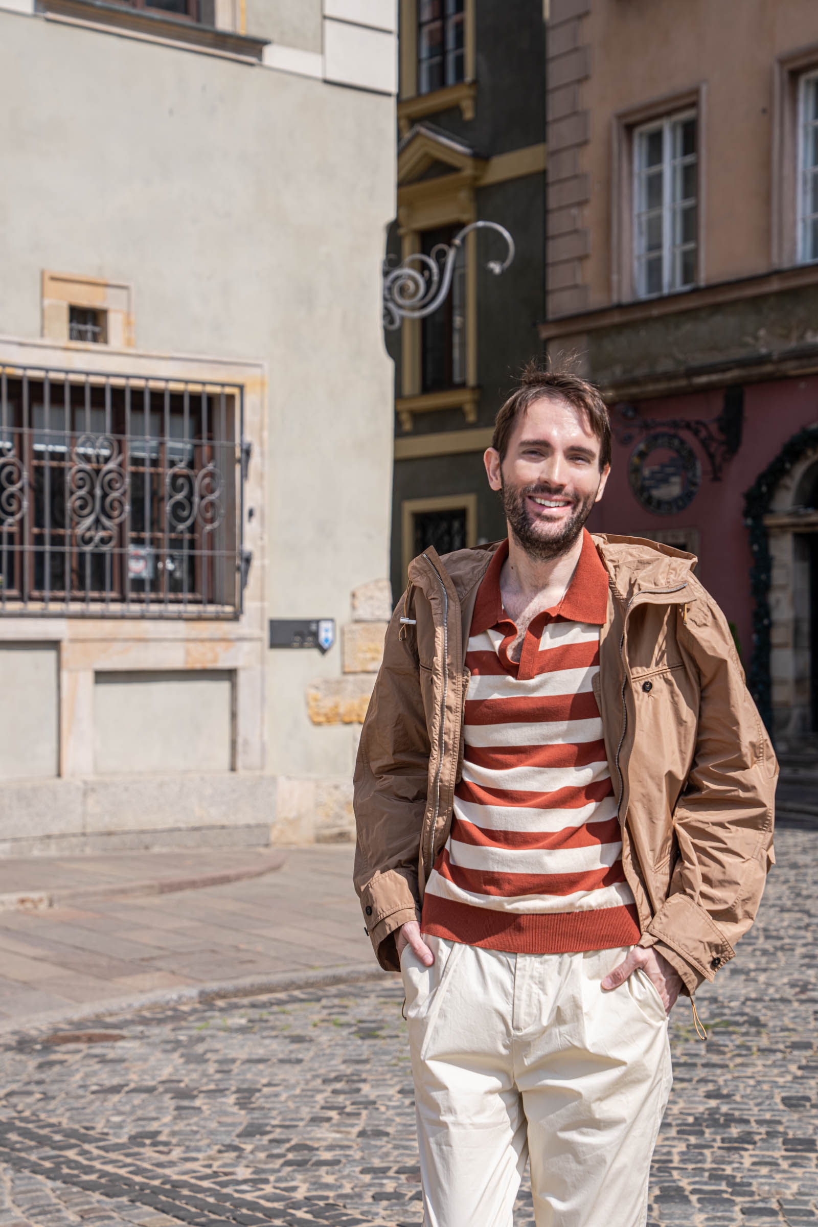 Marko Tadić standing in front of the Kamienne Schodki restaurant in a Ferragamo hooded jacket and striped knit polo