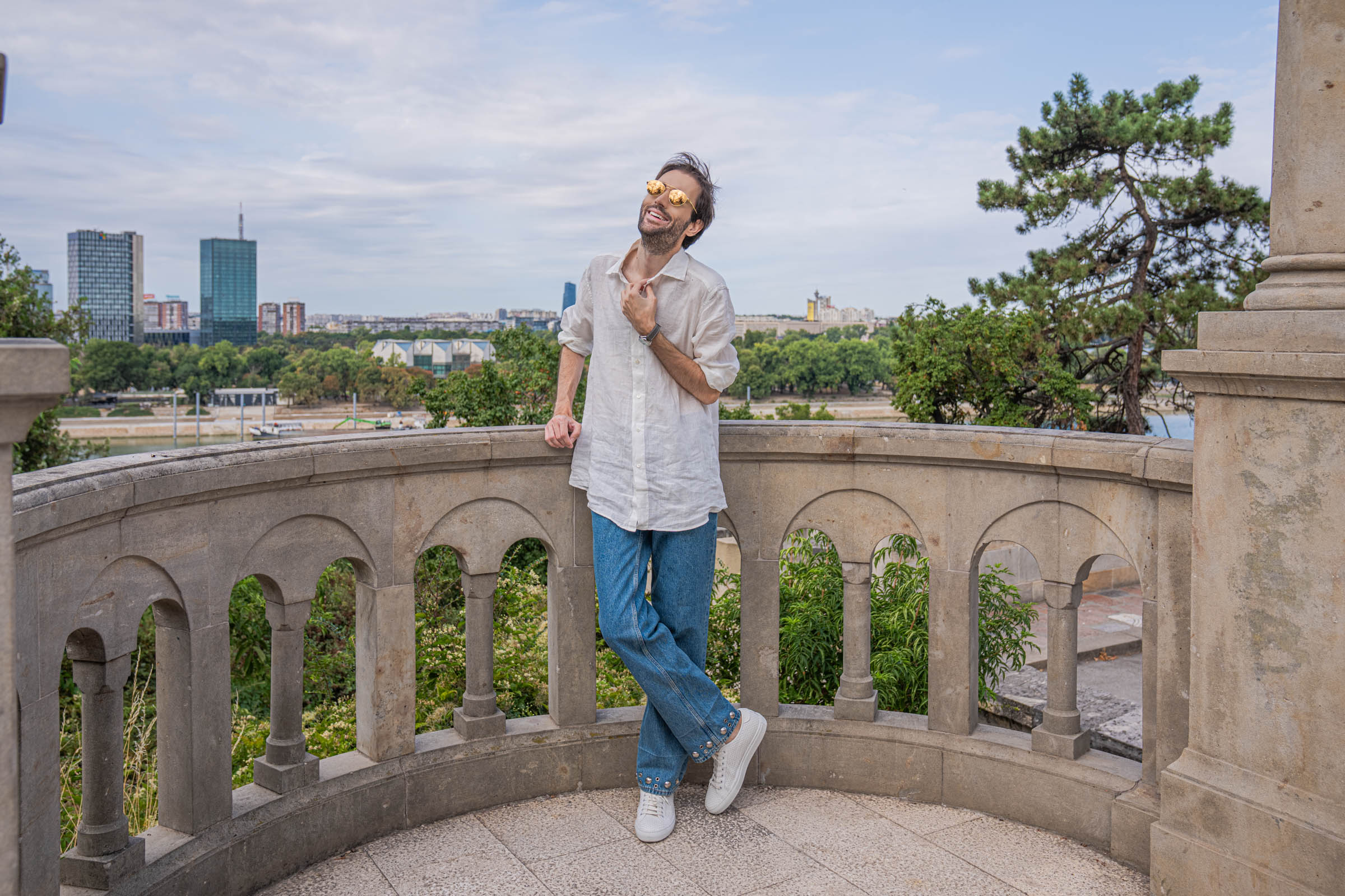 Marko Tadić resting one foot on a stone ledge in his Valentino summer outfit