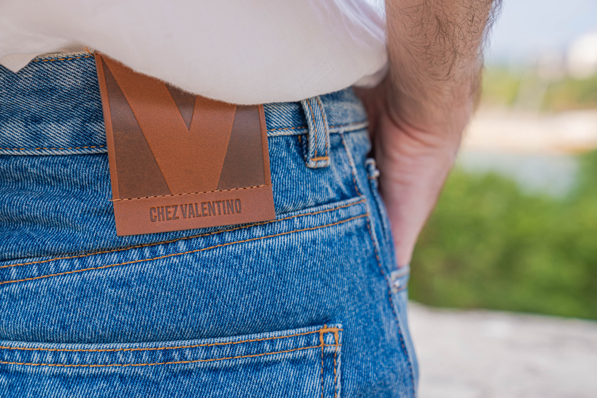 "Chez Valentino" leather logo patch on the Valentino jeans worn by Marko Tadić