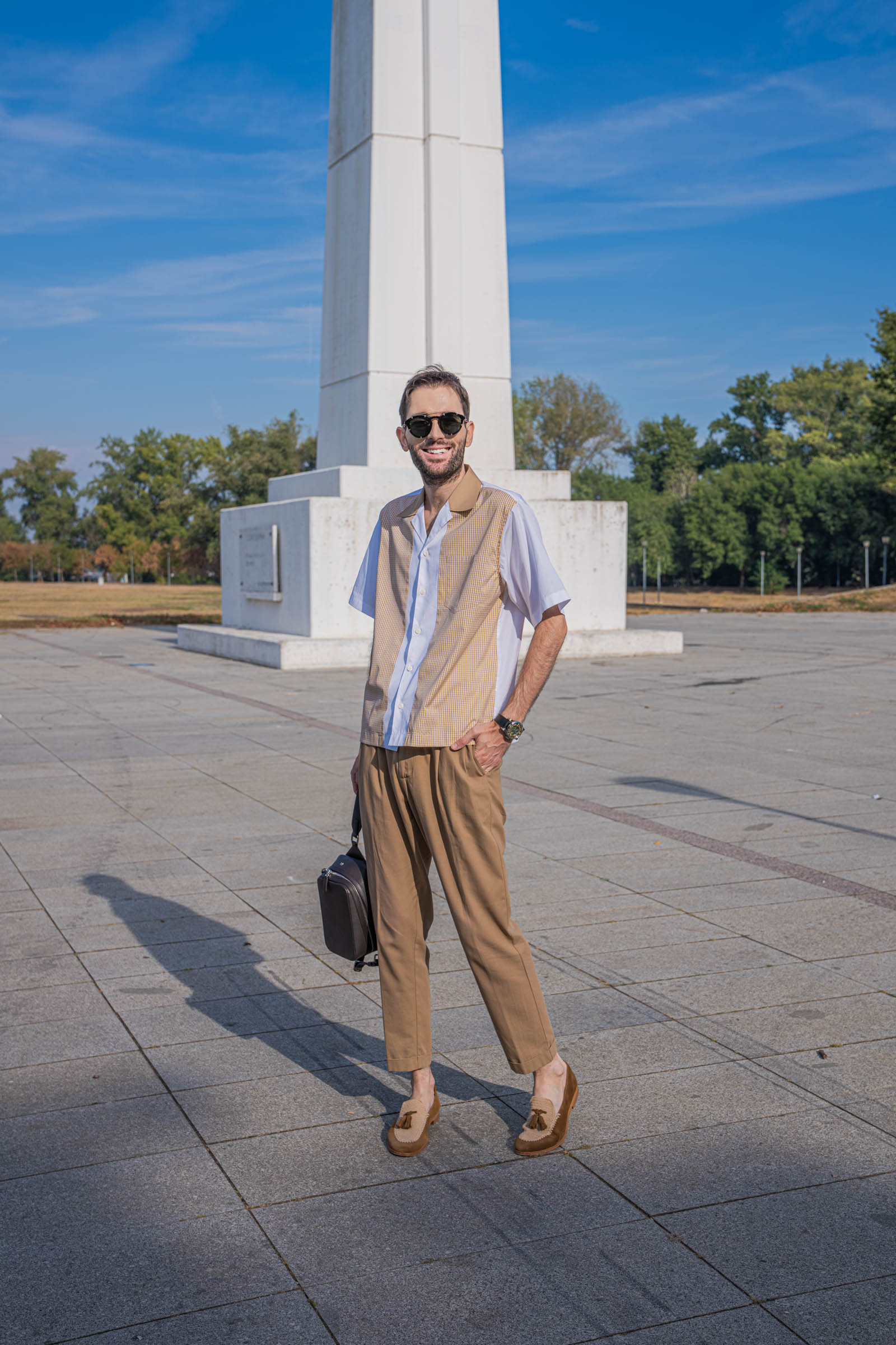 Mr.M blog founder Marko Tadić walks in a Dsquared2 outfit, carrying the dark brown 1900 Tempo Grande Crossbody bag by hand, with Fratelli Rossetti Brera loafers