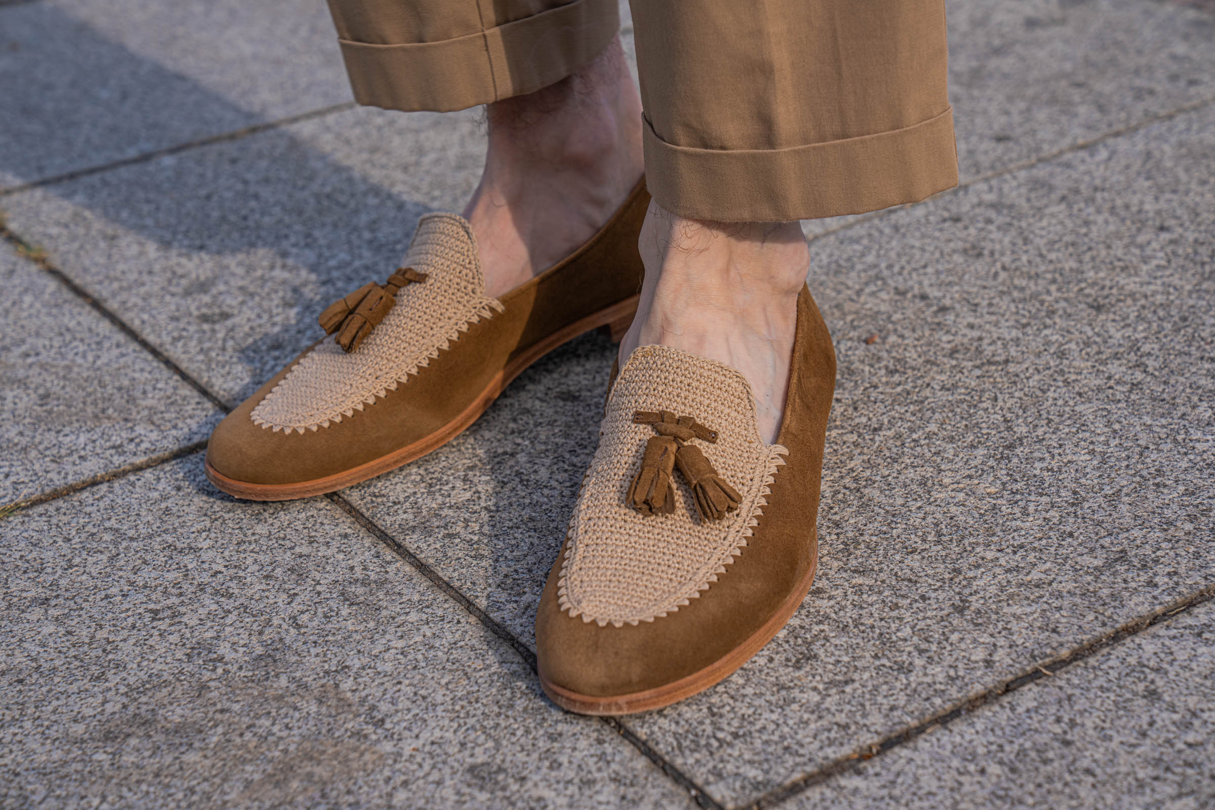 Close-up of Fratelli Rossetti Brera loafers in tobacco brown suede with beige crochet vamp and suede tassels, worn by Marko Tadić with cropped Dsquared2 trousers