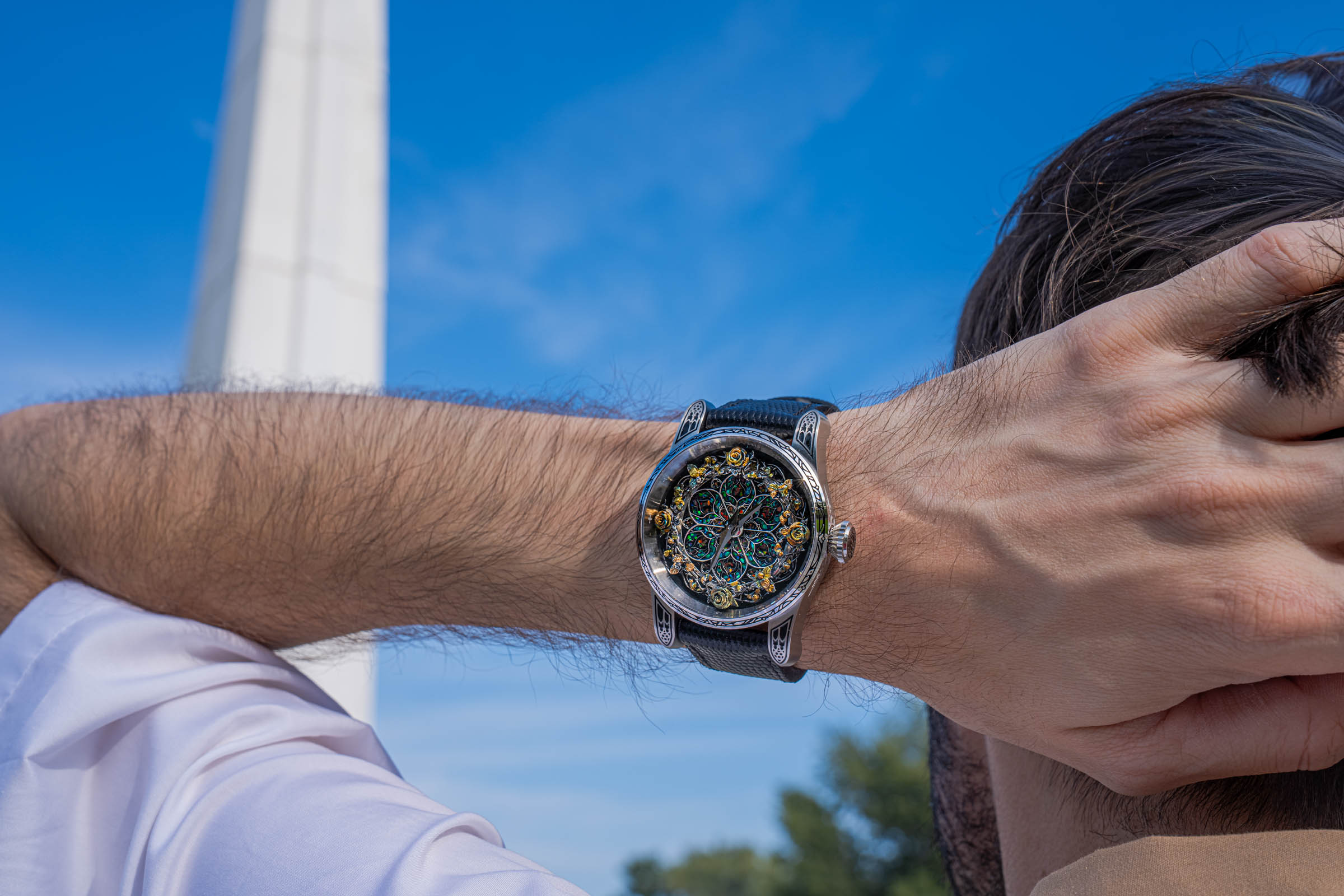 Marko Tadić, founder of Mr.M by Marko Tadić, raises his arm to show the Bard's Whisper Divine Comedy watch with sterling silver dial and black textured strap