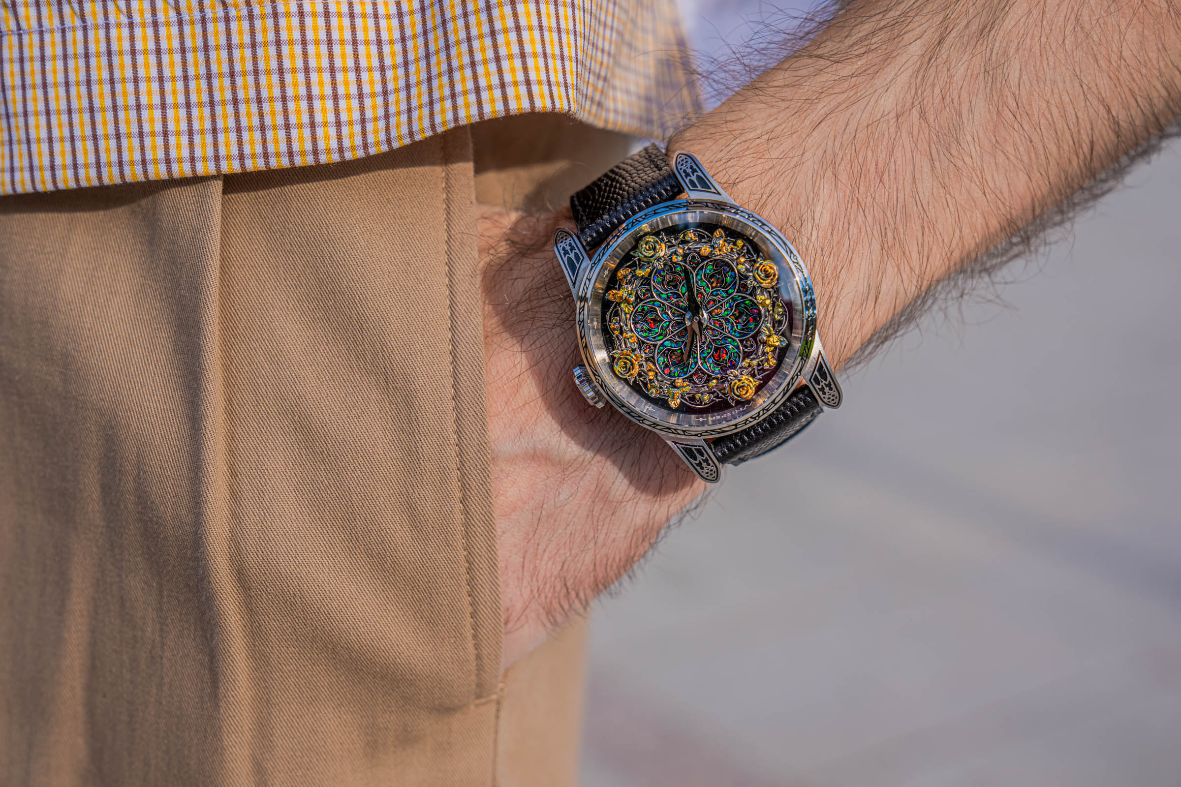 Detail of the Bard's Whisper Purgatorio Opal Crystal watch with green and red opal flashes, paired by Marko Tadić with a warm-toned Dsquared2 outfit