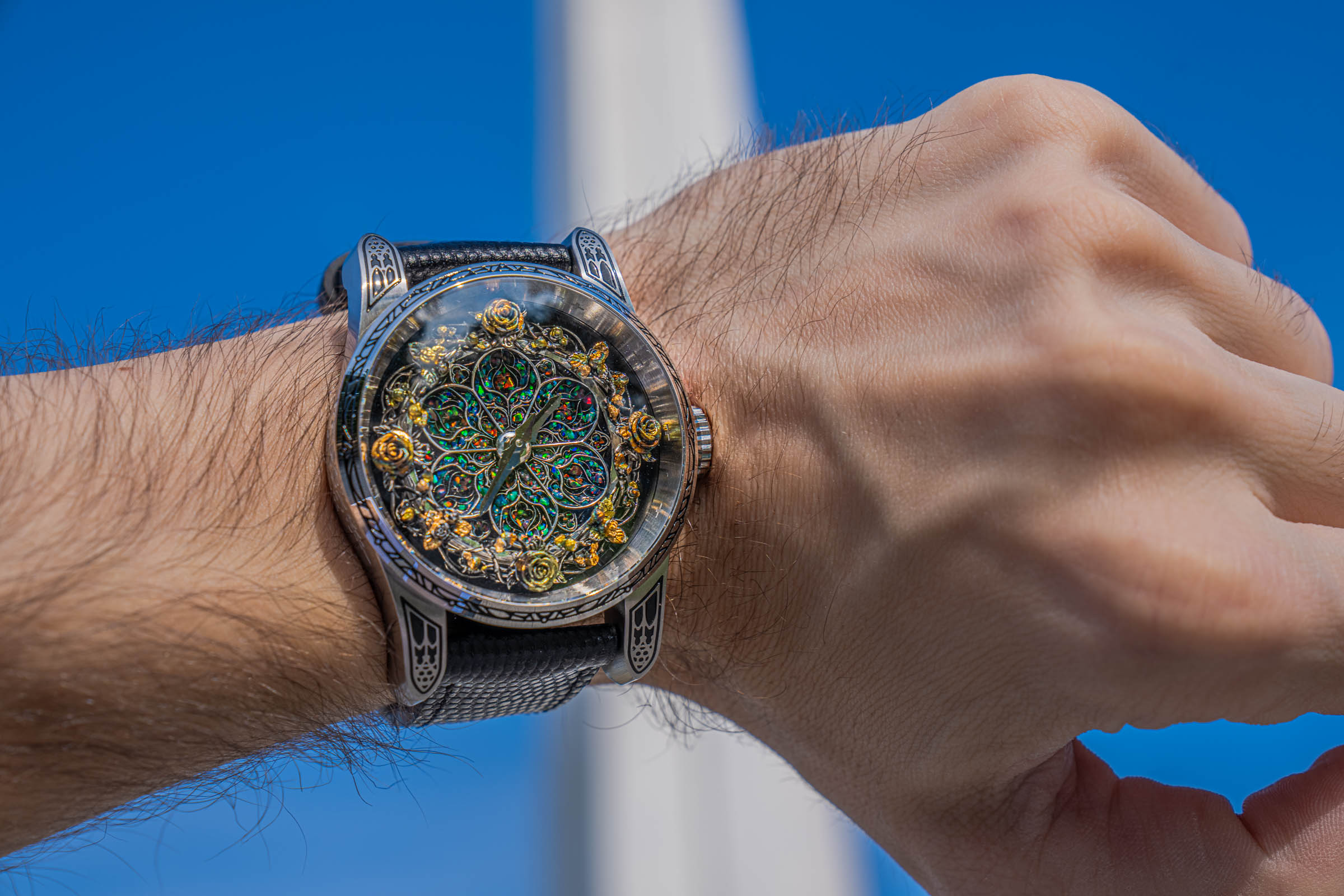 Close-up of the Bard's Whisper Opal Crystal dial with hand-cast S925 silver tracery, gilded roses and Gothic window lugs on the wrist of Marko Tadić