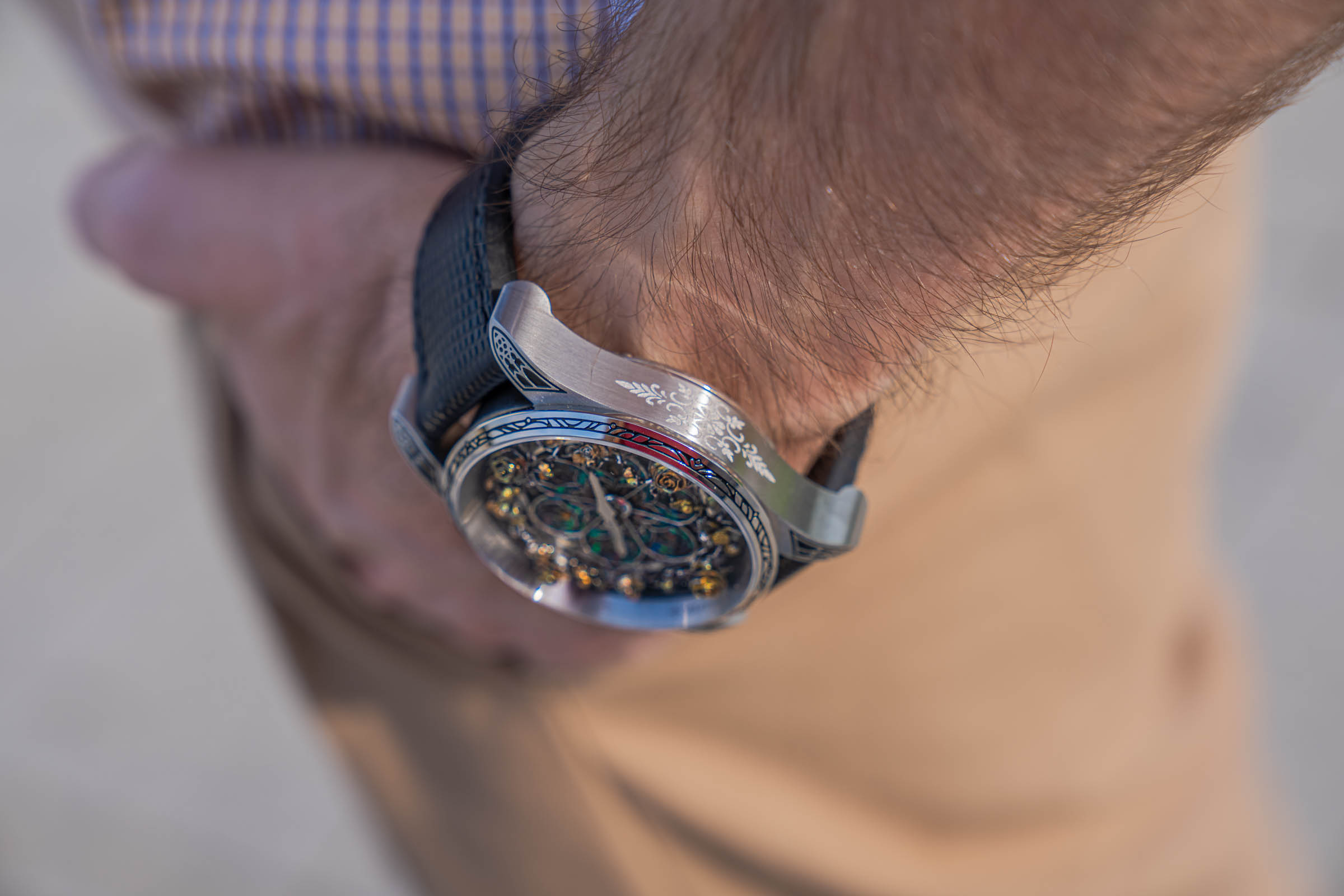 Side profile of the Bard's Whisper watch worn by Marko Tadić, revealing the floral decoration on the case flank, curved lugs and Gothic bezel tracery