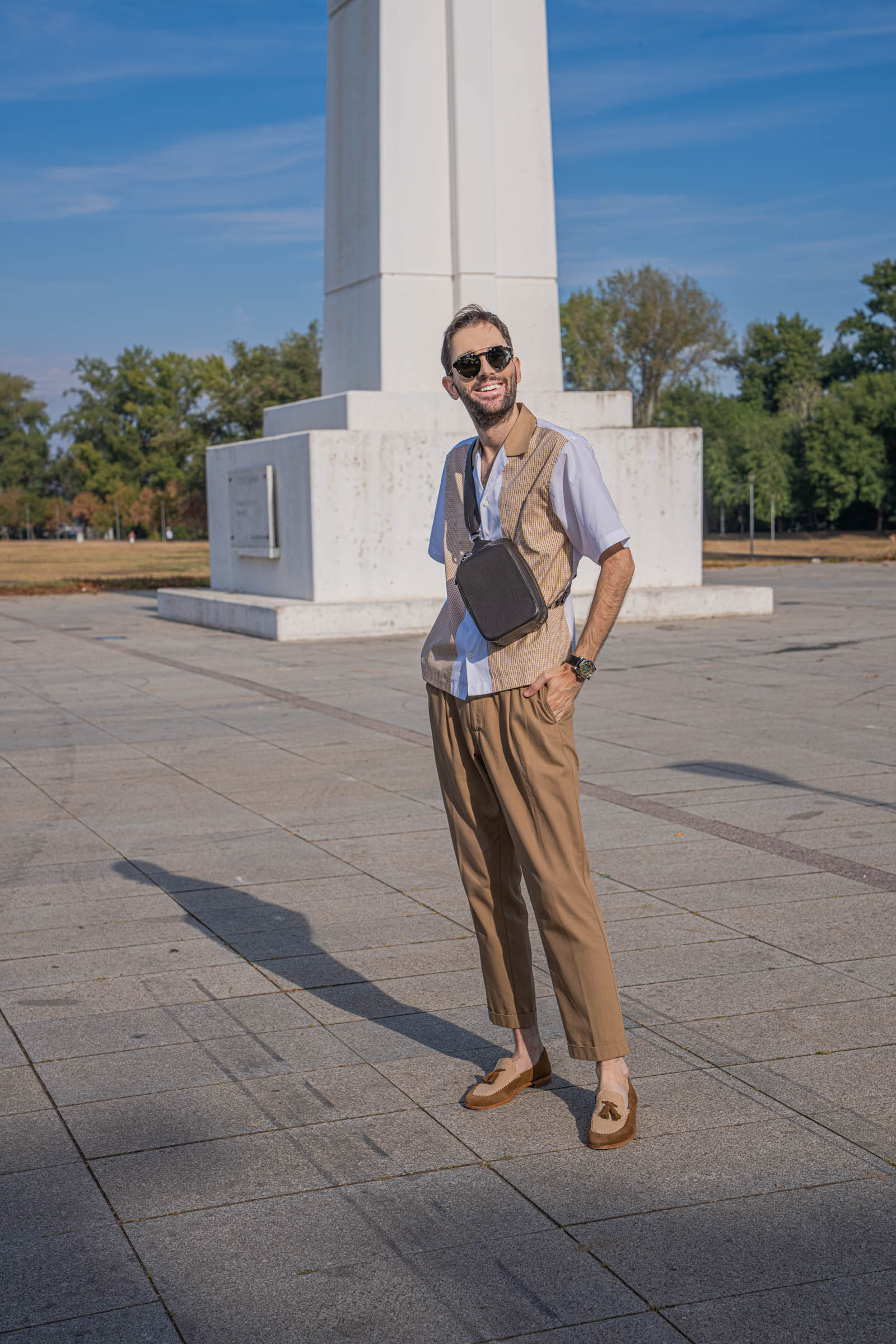 Marko Tadić of the Mr.M blog wears the 1900 Tempo Grande Crossbody bag across his chest over a Dsquared2 outfit in white, mustard and tan tones