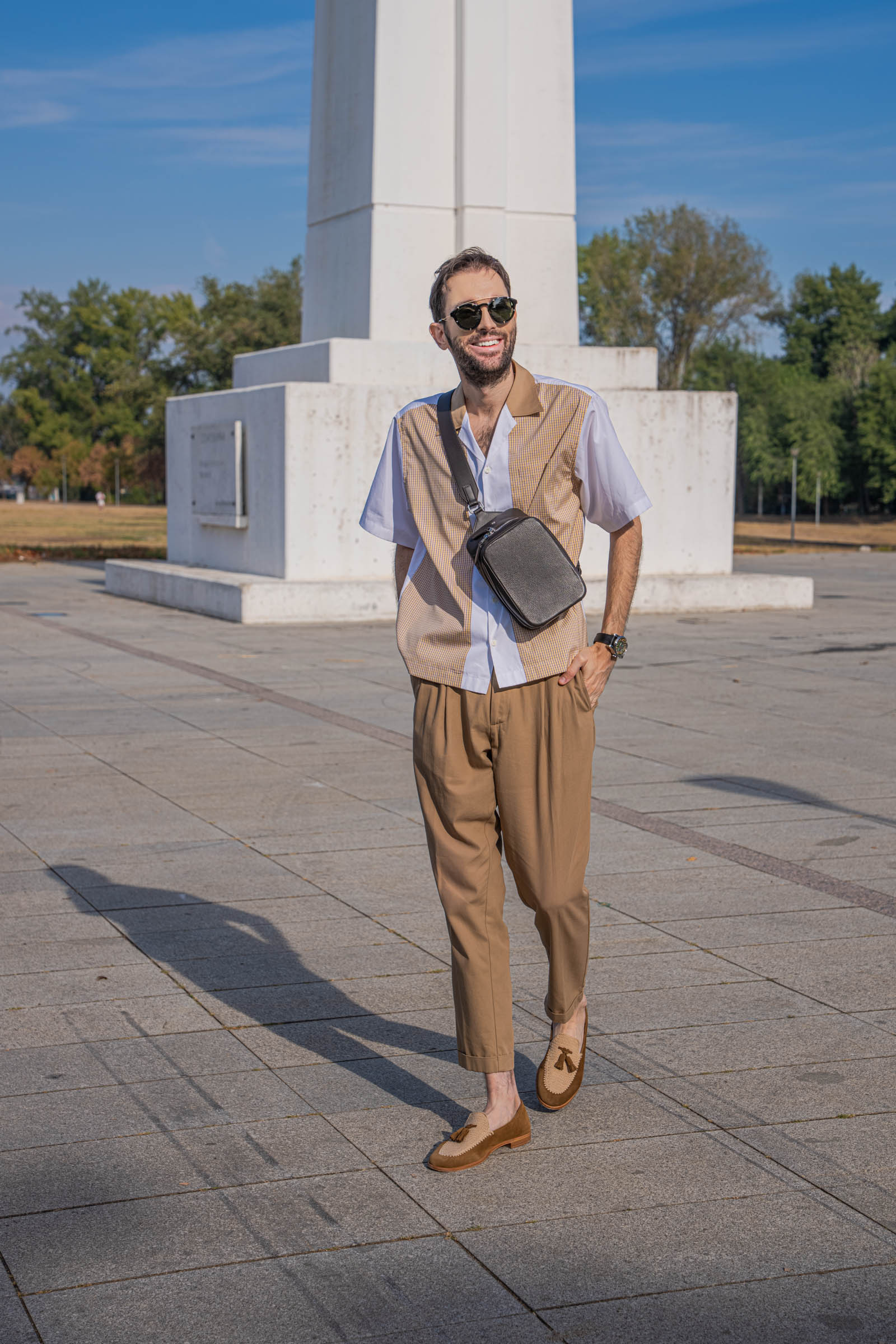 Marko Tadić walking with a smile in a full Dsquared2 outfit, the 1900 crossbody bag across his chest and Fratelli Rossetti crochet tassel loafers on his feet