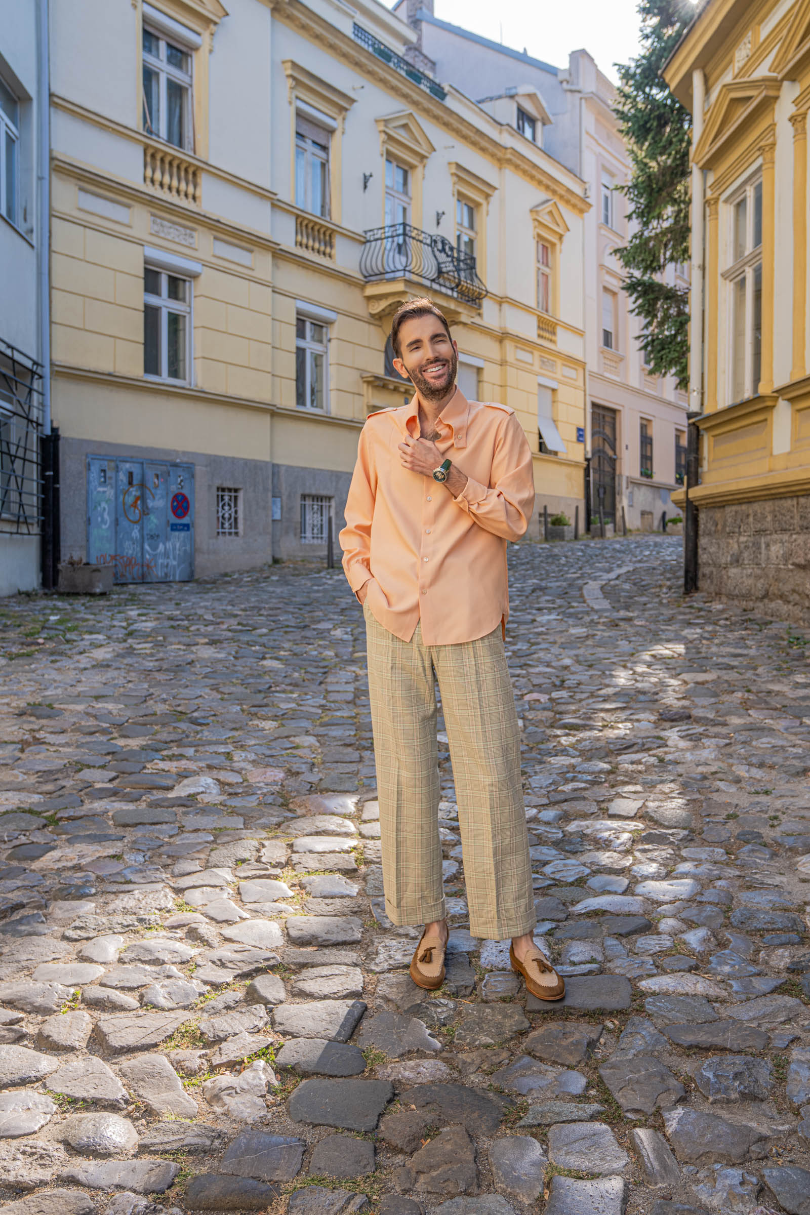 Marko Tadić adjusts his shirt cuff to reveal the Dmitry Chugunov watch, styled with light green Gucci check trousers
