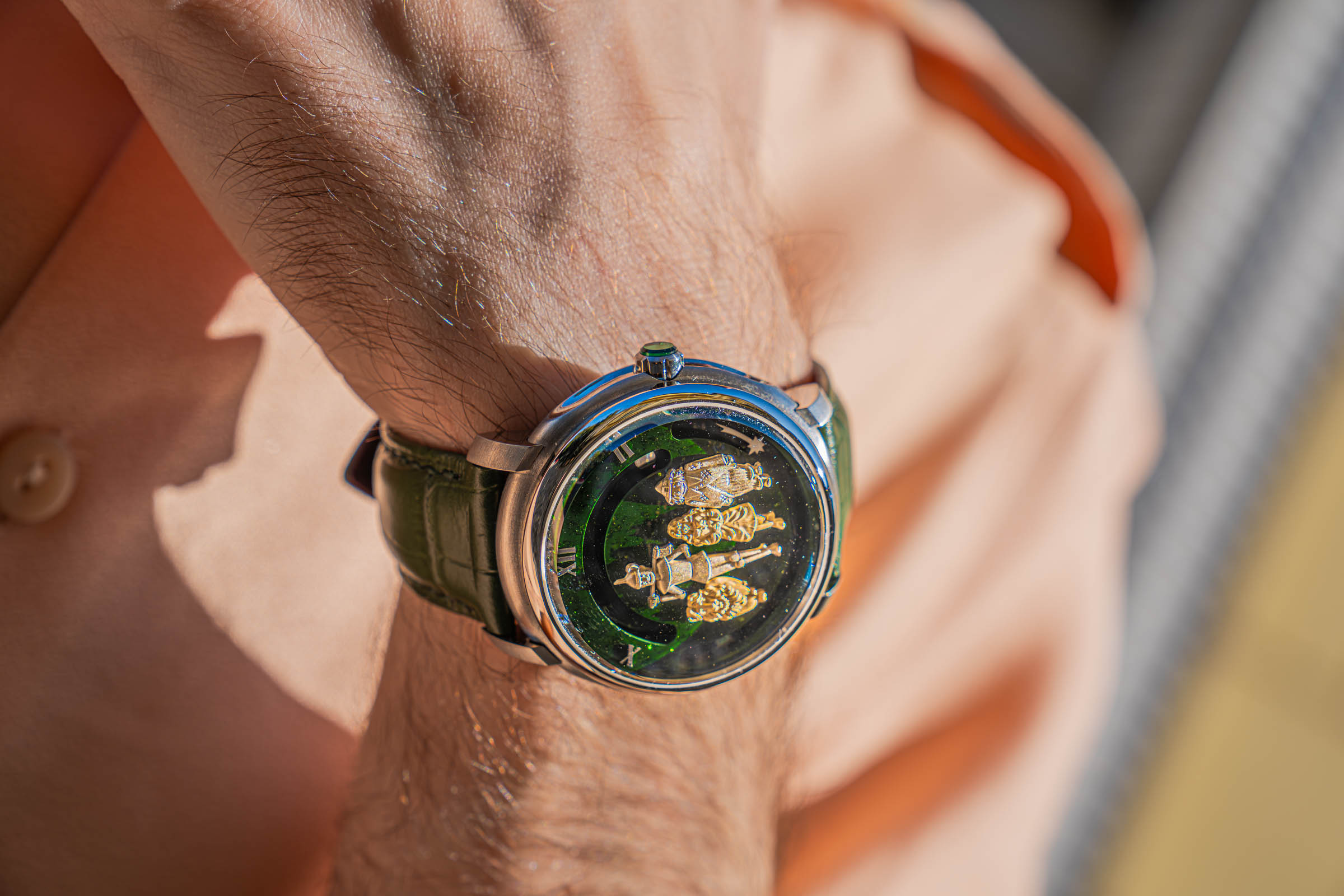 Roman numerals, polished steel case and green crown stone of the Dmitry Chugunov watch on Marko Tadić's wrist
