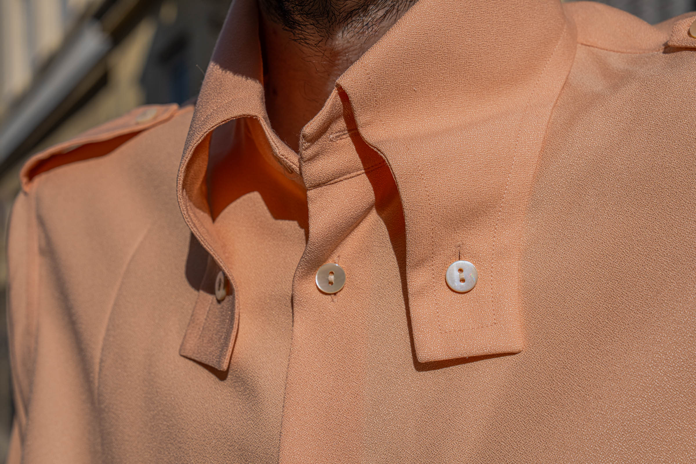 Macro detail of peach crepe silk, collar point and epaulette of the Gucci shirt worn by Marko Tadić