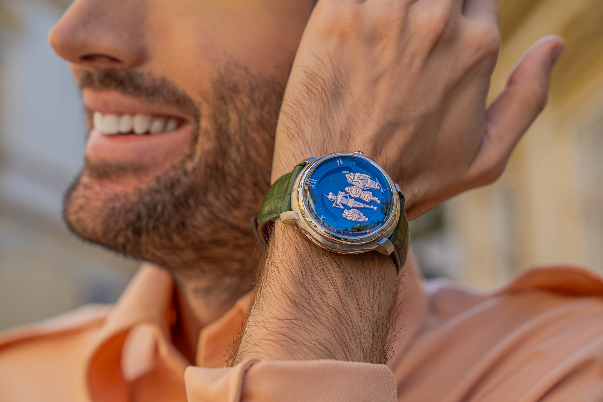 Marko Tadić raises the Dmitry Chugunov Wizard of the Emerald City watch, its aventurine dial glowing deep blue