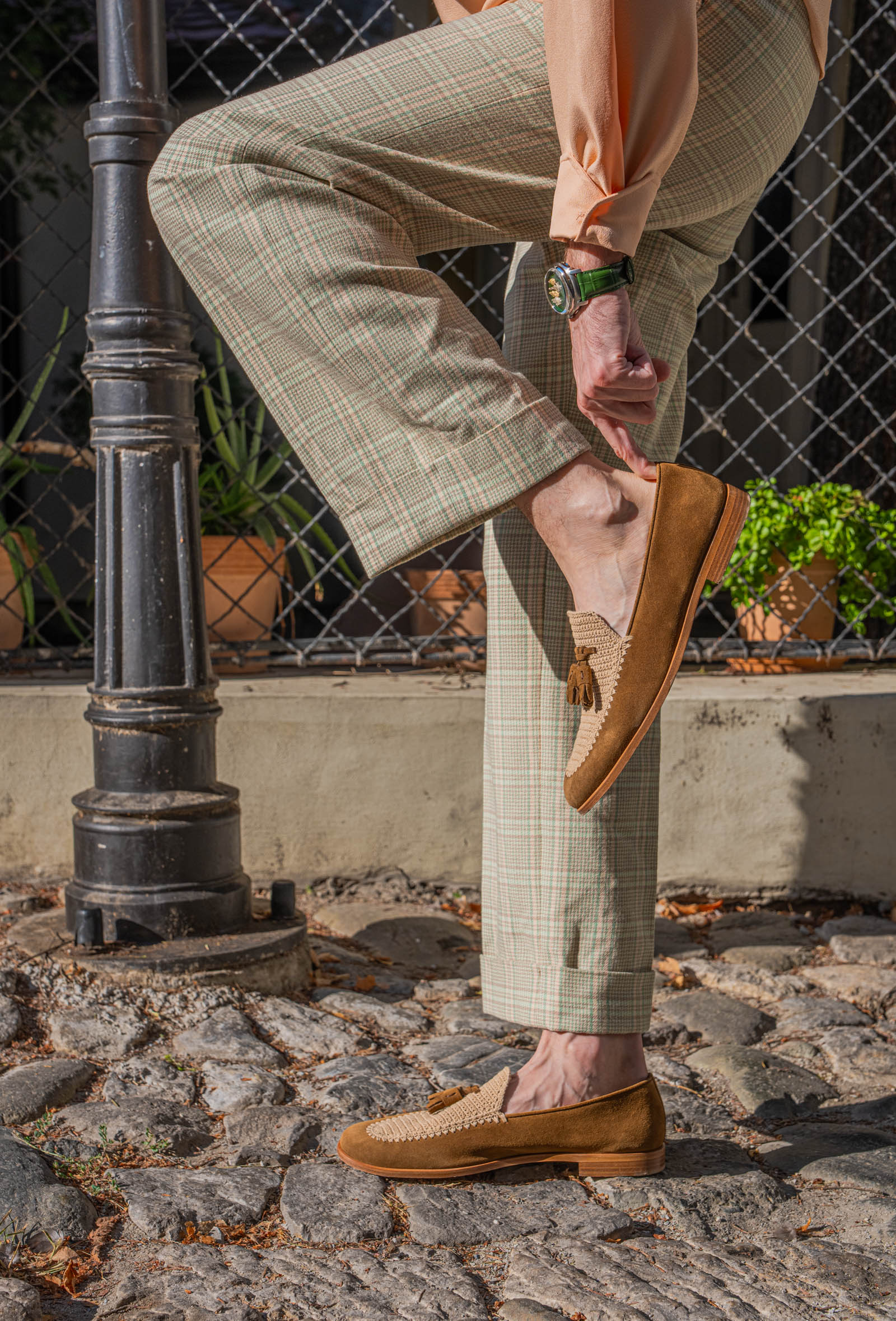 Marko Tadić beside an iron lamp post, holding a Fratelli Rossetti Brera loafer, the Chugunov watch in view