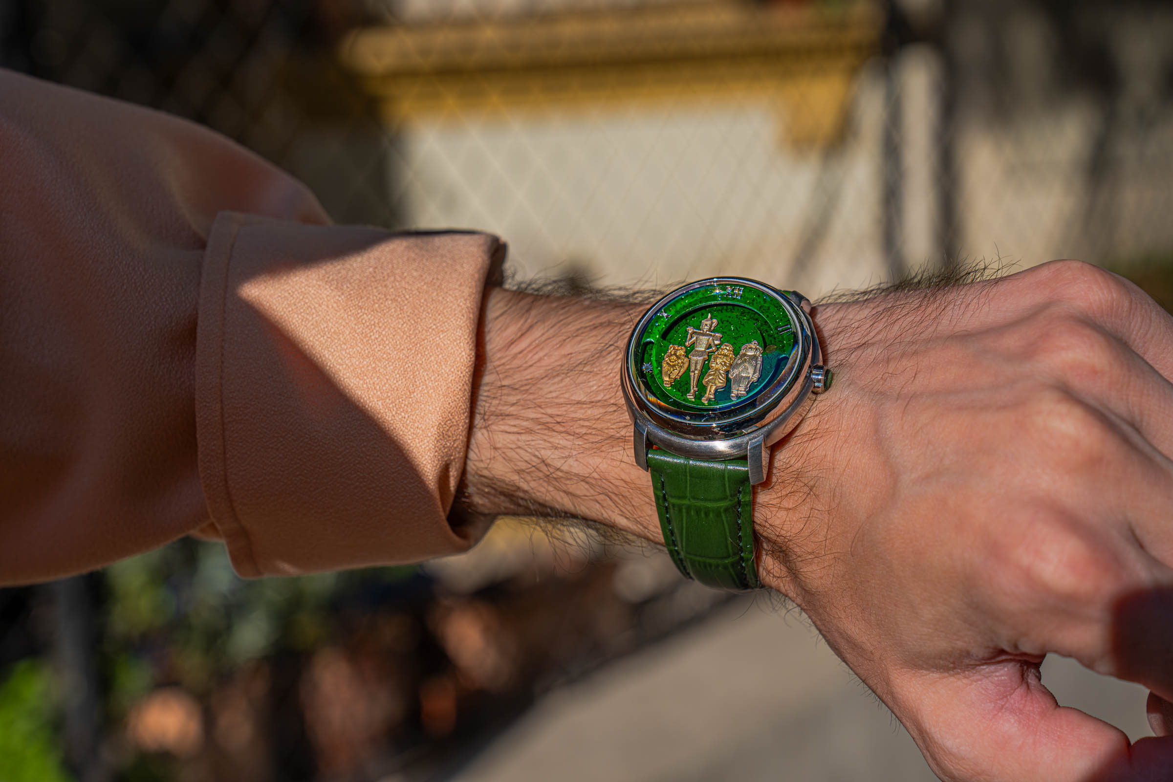 Dmitry Chugunov Wizard of Oz watch on a green croc-textured strap, worn by Marko Tadić with a peach silk shirt