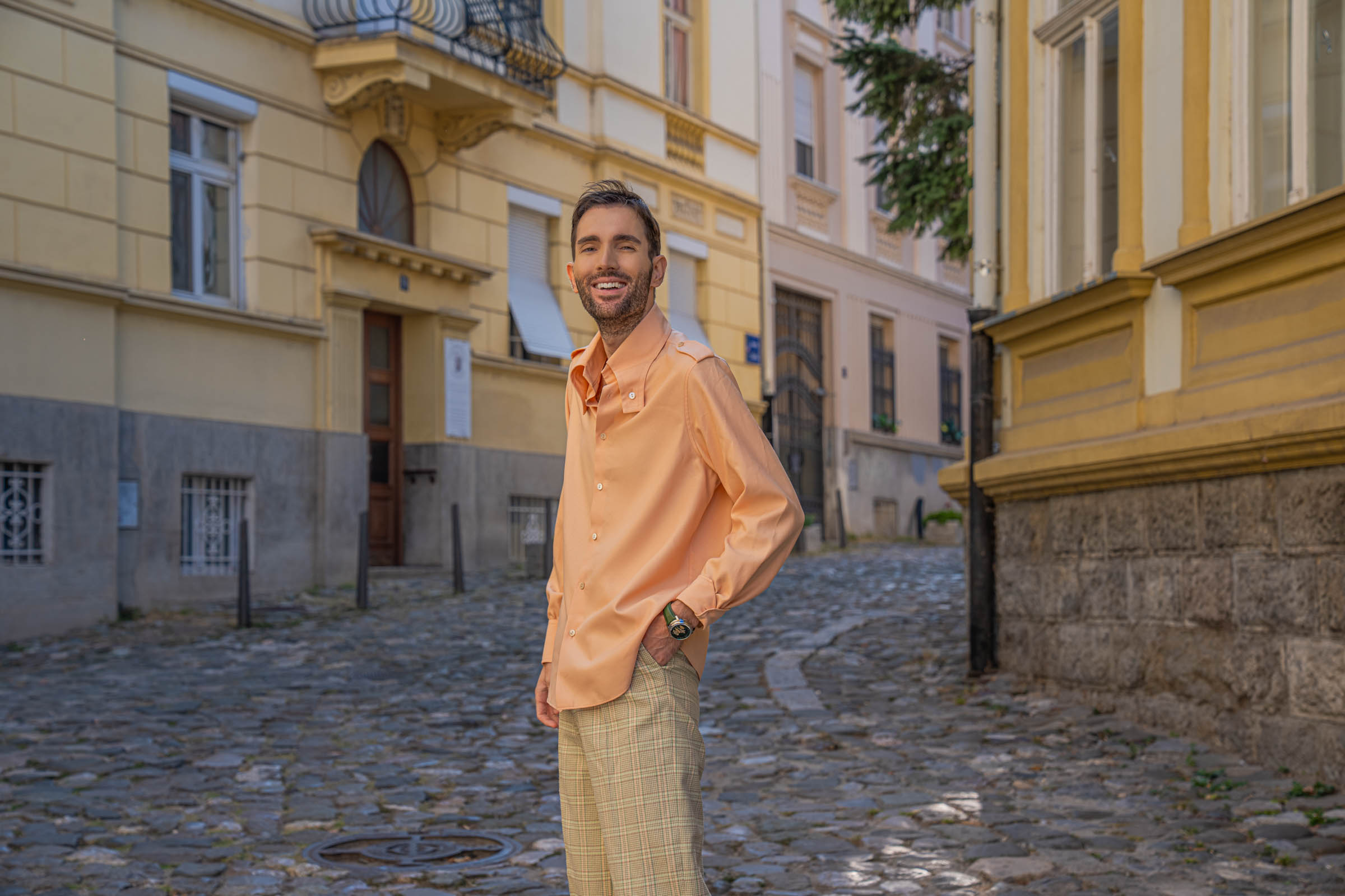 Smiling Marko Tadić of Mr.M in a peach Gucci silk shirt with button-down collar, the Chugunov watch at his wrist